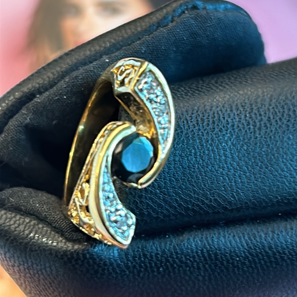 Gold ring with black  stone and clear stones